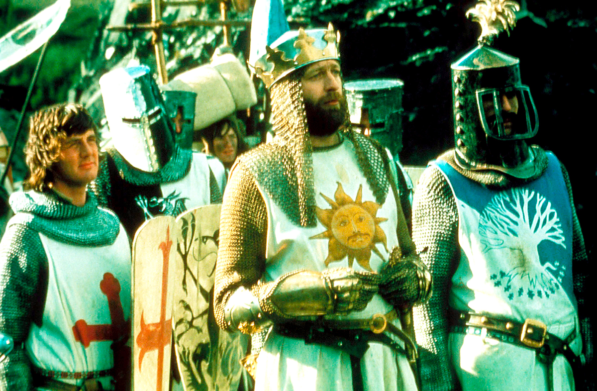 MONTY PYTHON AND THE HOLY GRAIL, Michael Palin (left), Graham Chapman as King Arthur (crown), Terry Jones (right), 1975