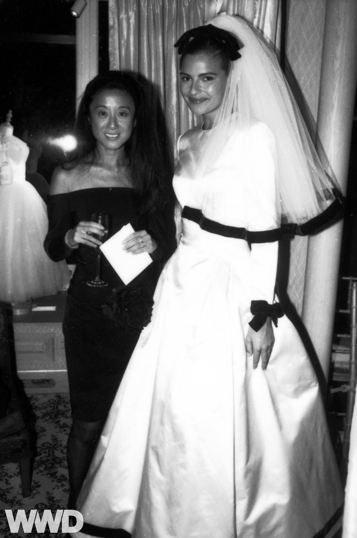 Fashion designer Vera Wang stands next to a model wearing her designs during her Bridal boutique party on September 14, 1990 in New York.