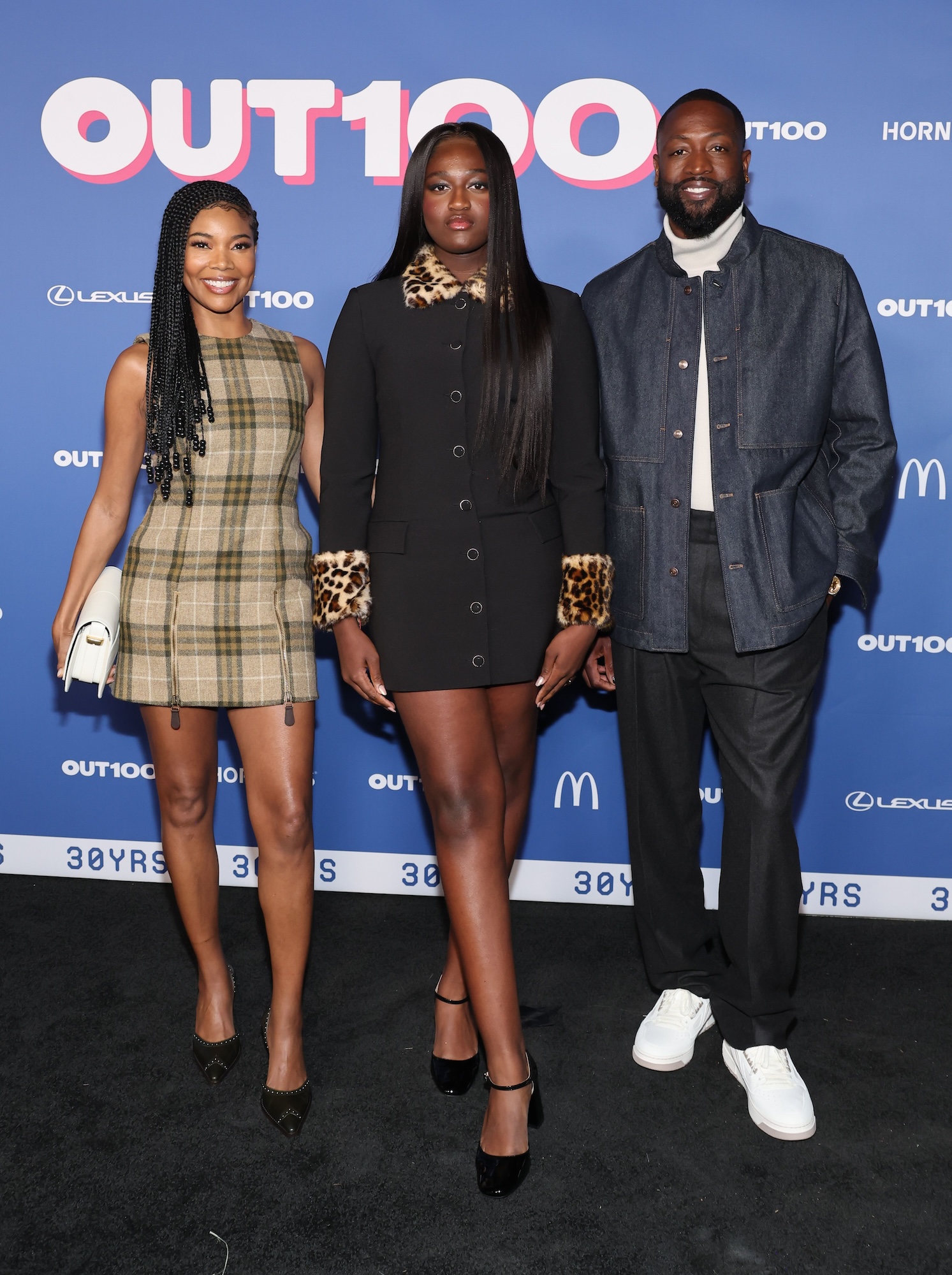 HOLLYWOOD, CALIFORNIA - DECEMBER 11: (L-R) Gabrielle Union, Zaya Wade and Dwyane Wade attend the Out100 Celebration at NeueHouse Hollywood on December 11, 2024 in Hollywood, California. (Photo by Amy Sussman/Getty Images)