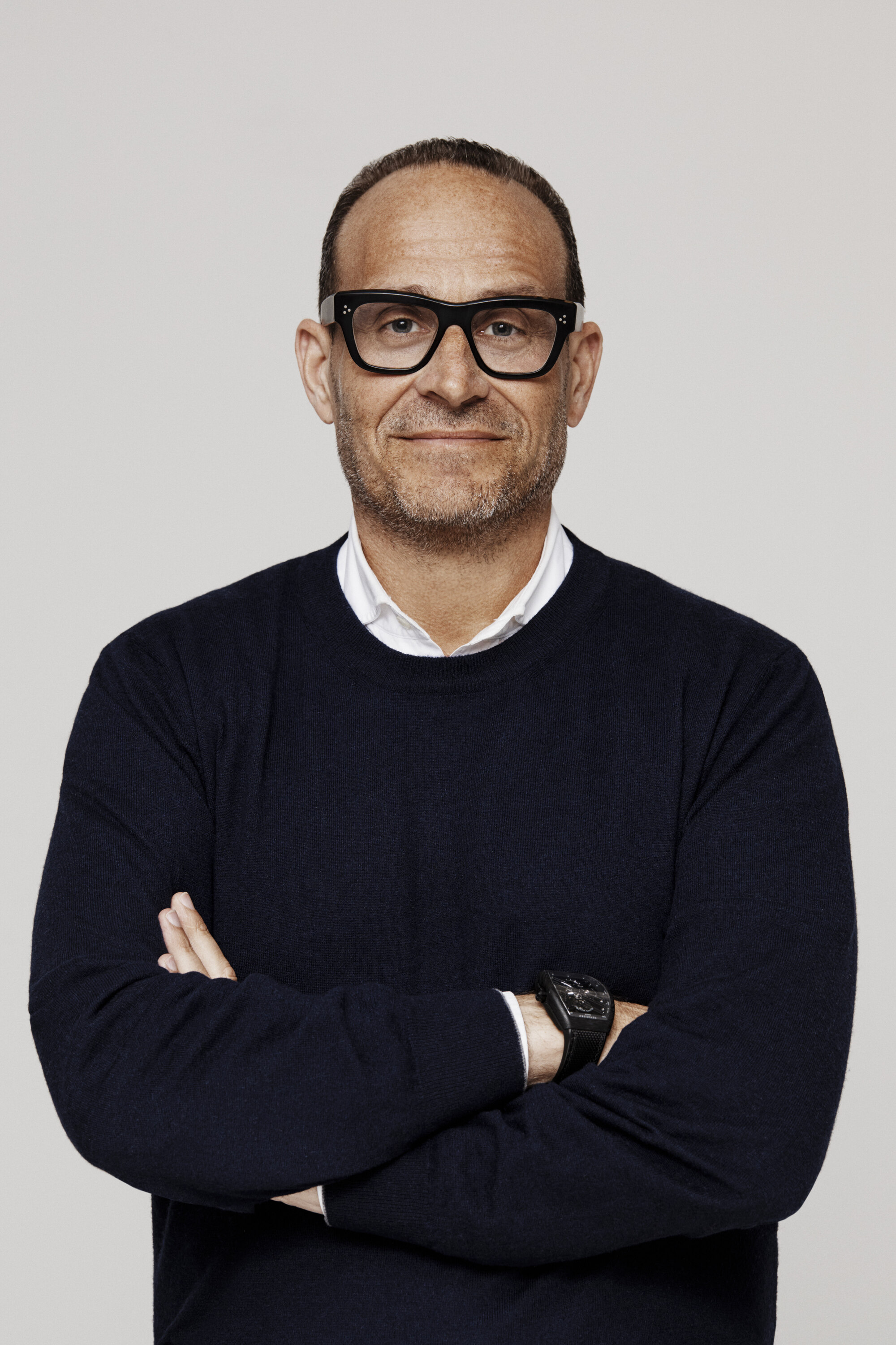 Mark Metrick in black sweater and glasses.