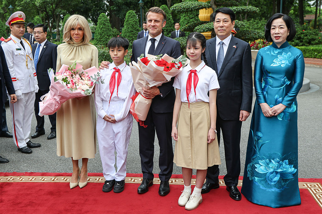 France's President Emmanuel Macron (C), Vietnam's President Luong Cuong (2nd R) and their wifes Brigitte Macron (L) and Nguyen Thi Minh Nguyet (R) pose during a welcoming ceremony at the Presidential Palace in Hanoi on May 26, 2025. (Photo by Ludovic MARIN / POOL / AFP) (Photo by LUDOVIC MARIN/POOL/AFP via Getty Images)