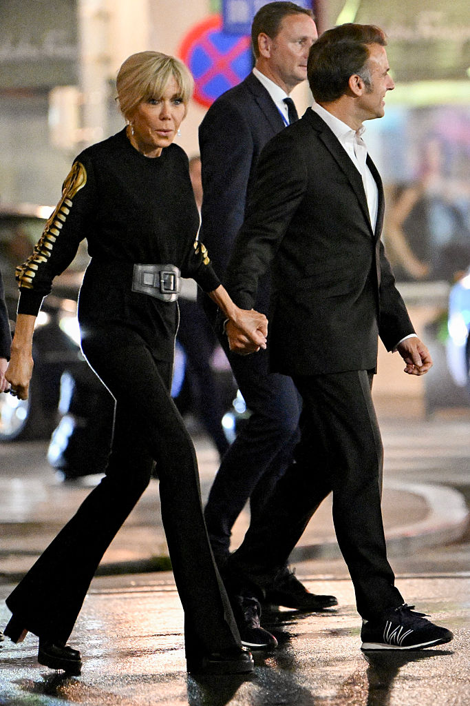 France's President Emmanuel Macron (R) and his wife Brigitte Macron (L) walk along a street in Hanoi on May 26, 2025. (Photo by Nhac NGUYEN / AFP) (Photo by NHAC NGUYEN/AFP via Getty Images)