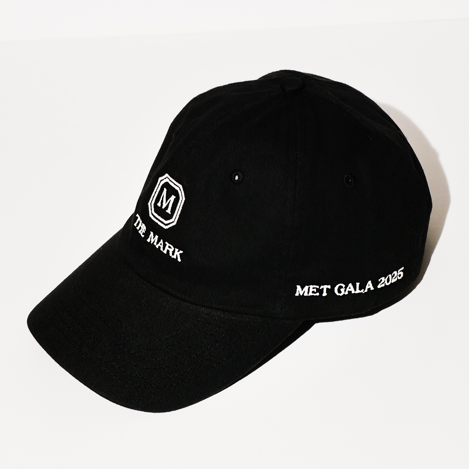 The Mark Hotel baseball cap for the 2025 Met Gala in black with white stitiching on a white backdrop