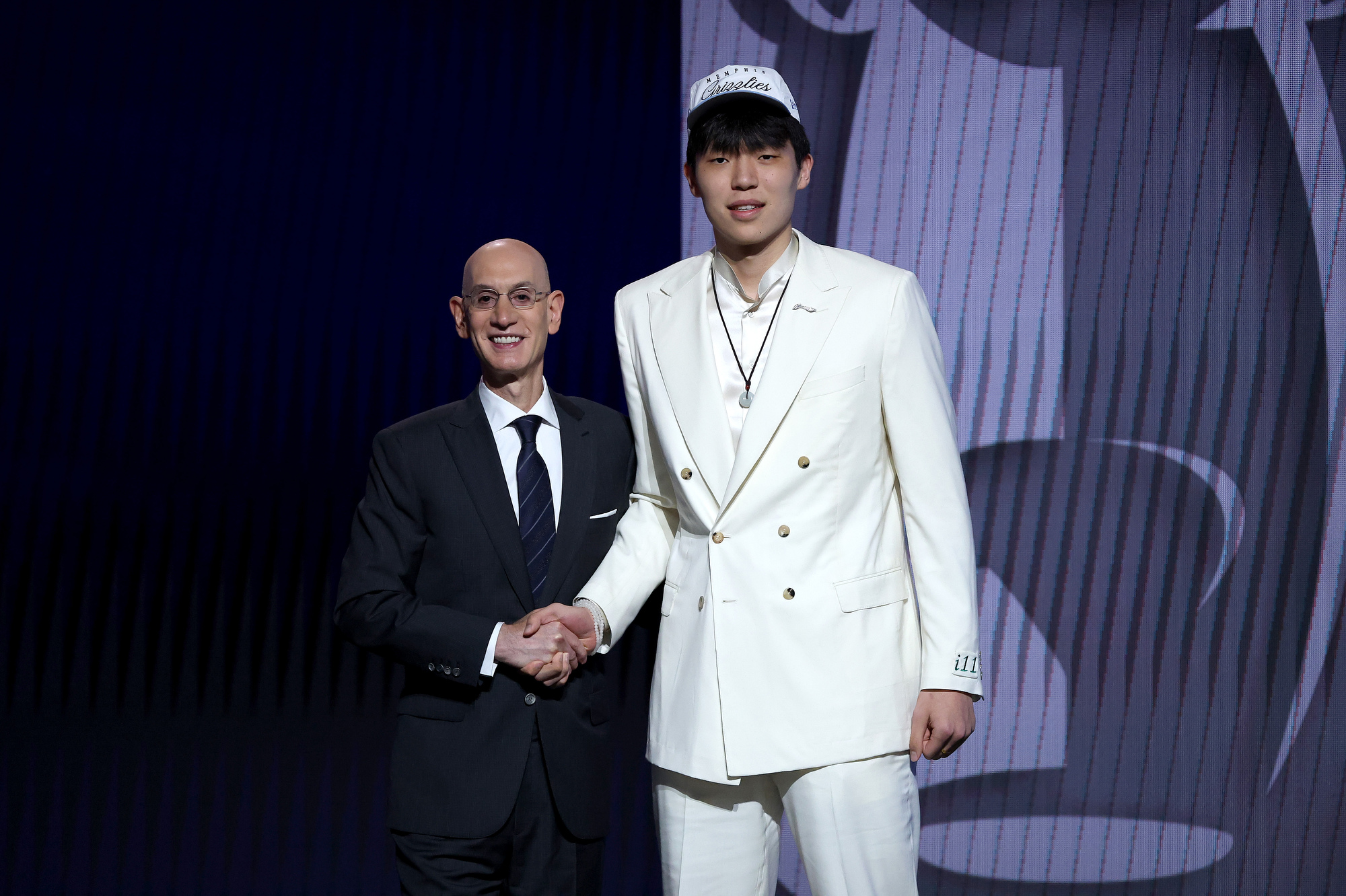 NEW YORK, NEW YORK - JUNE 25: Yang Hansen (R) shakes hands with NBA commissioner Adam Silver (L) after being drafted sixteenth overall by the Memphis Grizzlies during the first round of the 2025 NBA Draft at Barclays Center on June 25, 2025 in the Brooklyn borough of New York City. NOTE TO USER: User expressly acknowledges and agrees that, by downloading and/or using this photograph, user is consenting to the terms and conditions of the Getty Images License Agreement. (Photo by Sarah Stier/Getty Images)