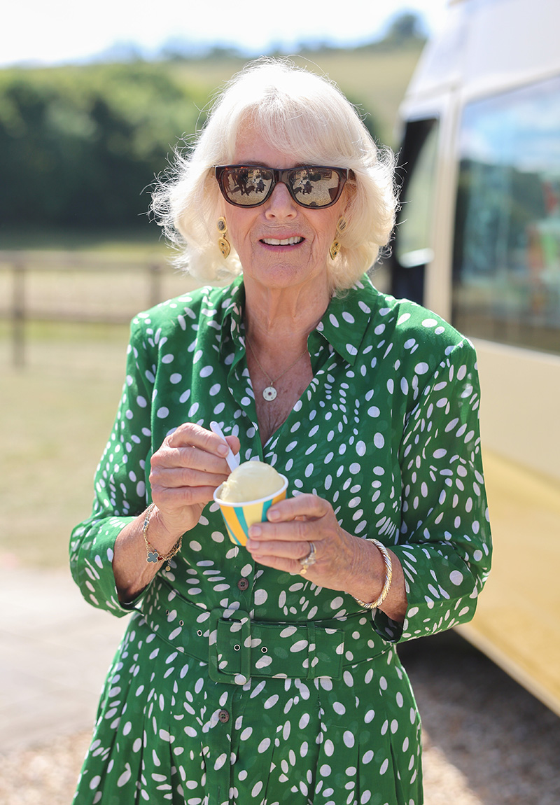 CALNE, ENGLAND - JULY 10: Queen Camilla smiles with an ice cream from Joanna Weaver's ice cream van during a visit to celebrate the 50th anniversary of the Wiltshire and Swindon Community Foundation at Manor Farm on July 10, 2025 in Calne, England. (Photo by Chris Jackson/Getty Images)