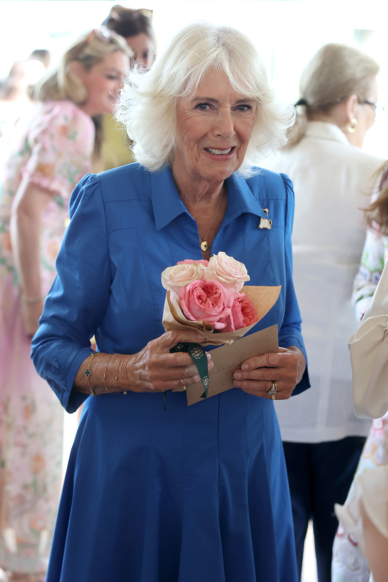LONDON, ENGLAND - JULY 14: Queen Camilla receives a bouquet of flowers during a visit to unveil the new RHS and BBC Radio 2 'Dog Garden', designed by Monty Don at Battersea Dogs & Cats Home on July 14, 2025 in London, England. (Photo by Chris Jackson/Getty Images)