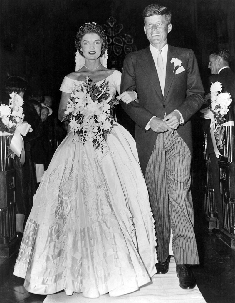 Senator John Fitzgerald Kennedy (1917 - 1963), Democratic senator for Massachusetts, escorts his bride Jacqueline Lee Bouvier (1929 - 1994) down the church aisle shortly after their wedding ceremony at Newport, Rhode Island. (Photo by Keystone/Getty Images)