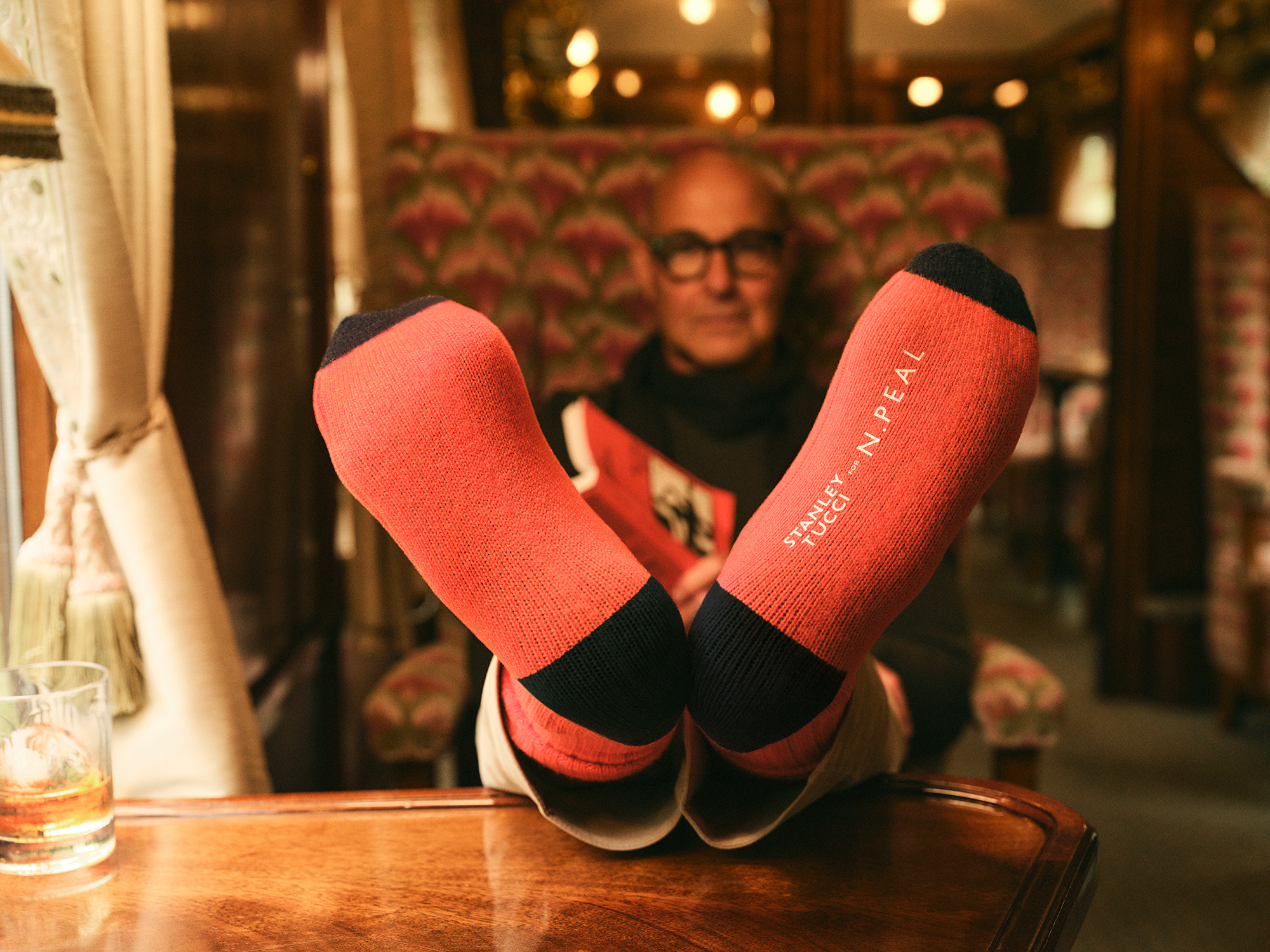 Stanley Tucci in the campaign for N. Peal’s new Art of Travelling collection.