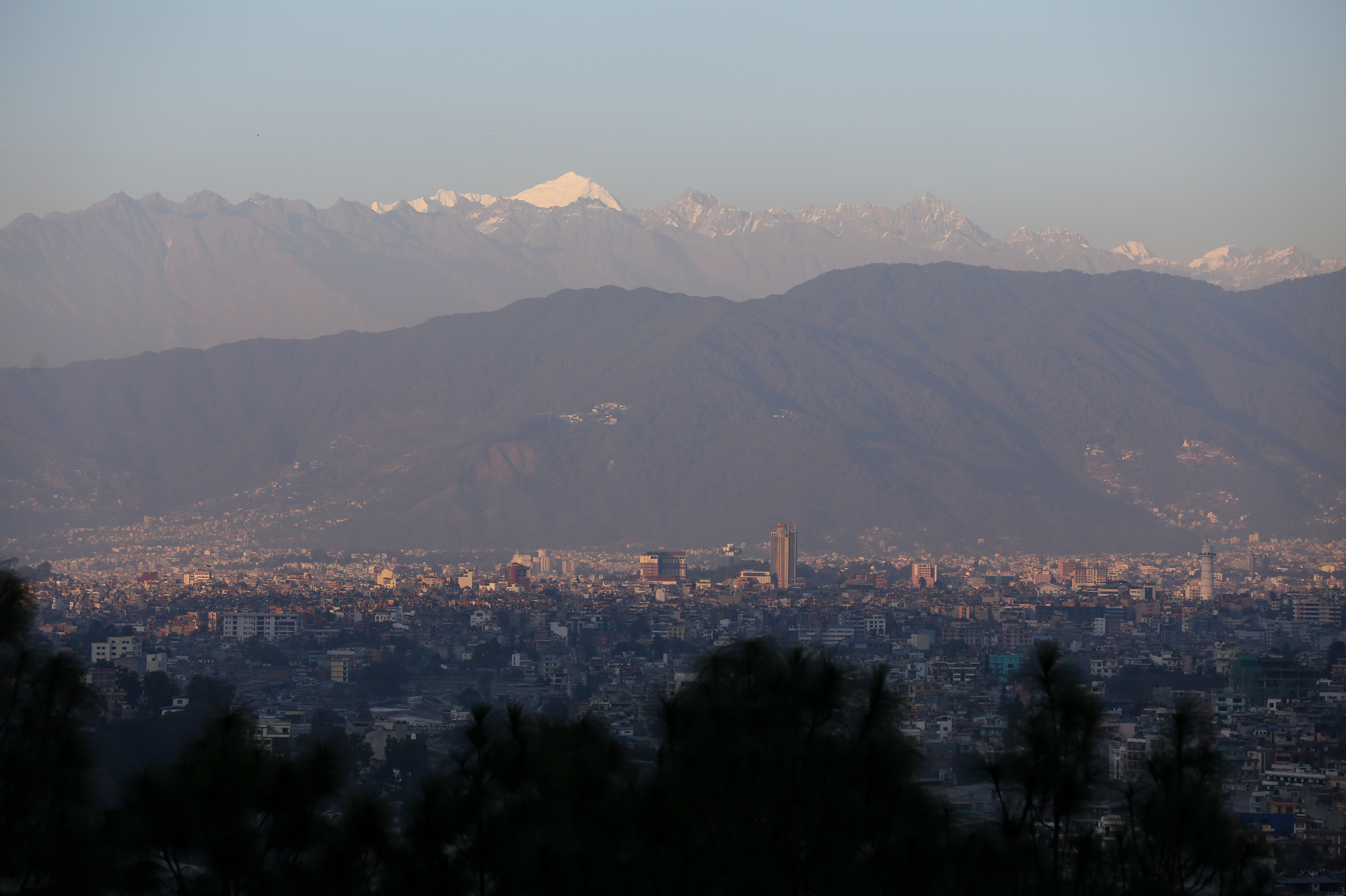 Mountain ranges covered in snow shine behind the hills surrounding the Kathmandu Valley on December 19, 2025. (Photo by Subaas Shrestha/NurPhoto via Getty Images)