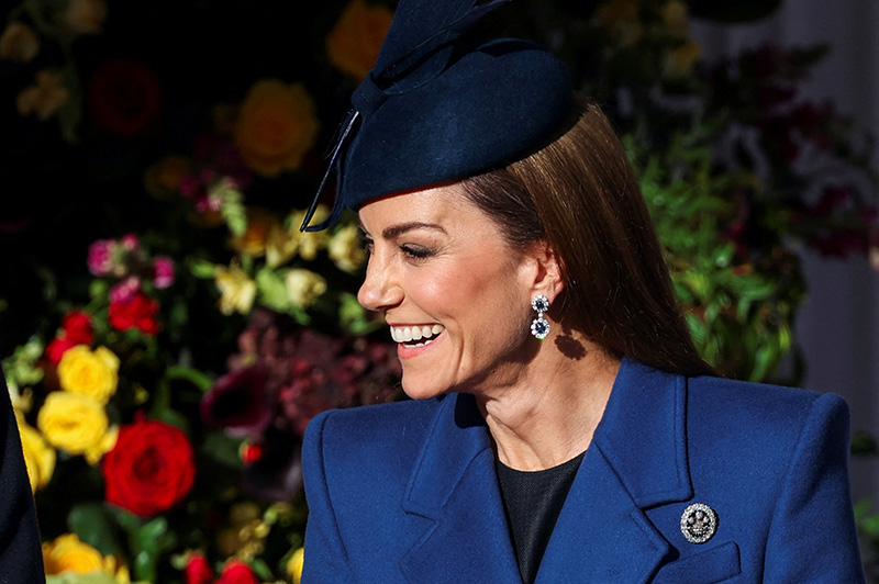 Kate Middleton wears a blue McQueen coat and Princess Diana's sapphire and diamond earrings at a welcome ceremony on the Royal Dais at Datchet Road on Dec. 3, 2025 in Windsor, England.
