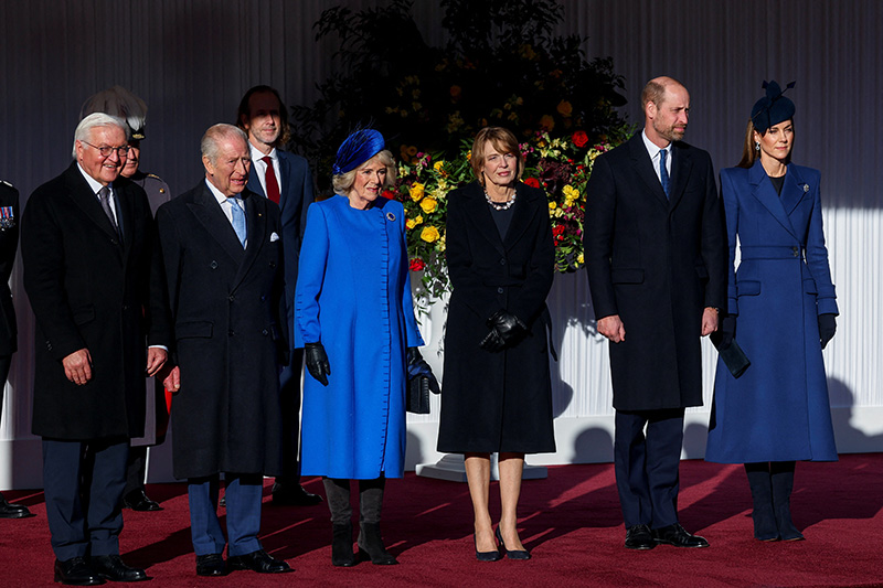 Kate Middleton wears a blue McQueen coat and Princess Diana's sapphire and diamond earrings at a welcome ceremony on the Royal Dais at Datchet Road on Dec. 3, 2025 in Windsor, England.