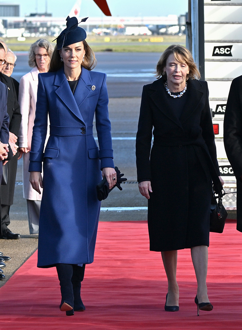 Kate Middleton wears a blue McQueen coat and Princess Diana's sapphire and diamond earrings at a welcome ceremony on the Royal Dais at Datchet Road on Dec. 3, 2025 in Windsor, England.