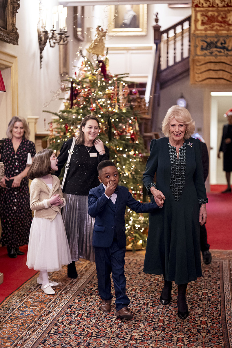 Queen Camilla wears a green dress and a hummingbird brooch by Van Cleef & Arpels during the Christmas tree decorating event supported by Helen and Douglas House and Roald Dahl's, Marvellous Children's Charity, at Clarence House in London on Dec. 11, 2025.