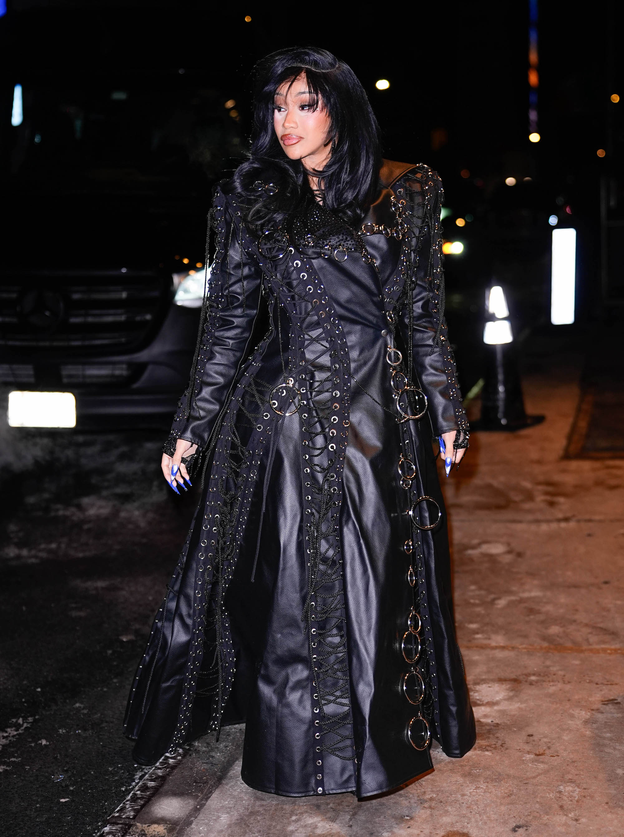 Cardi B is seen in a Bryan Hearns leather trench as she arrived at her hotel after performing on Saturday Live’s 1,000th Episode on Feb. 1, 2026 in New York City. Cardi B style, leather trench, metal grommets, celebrity street style